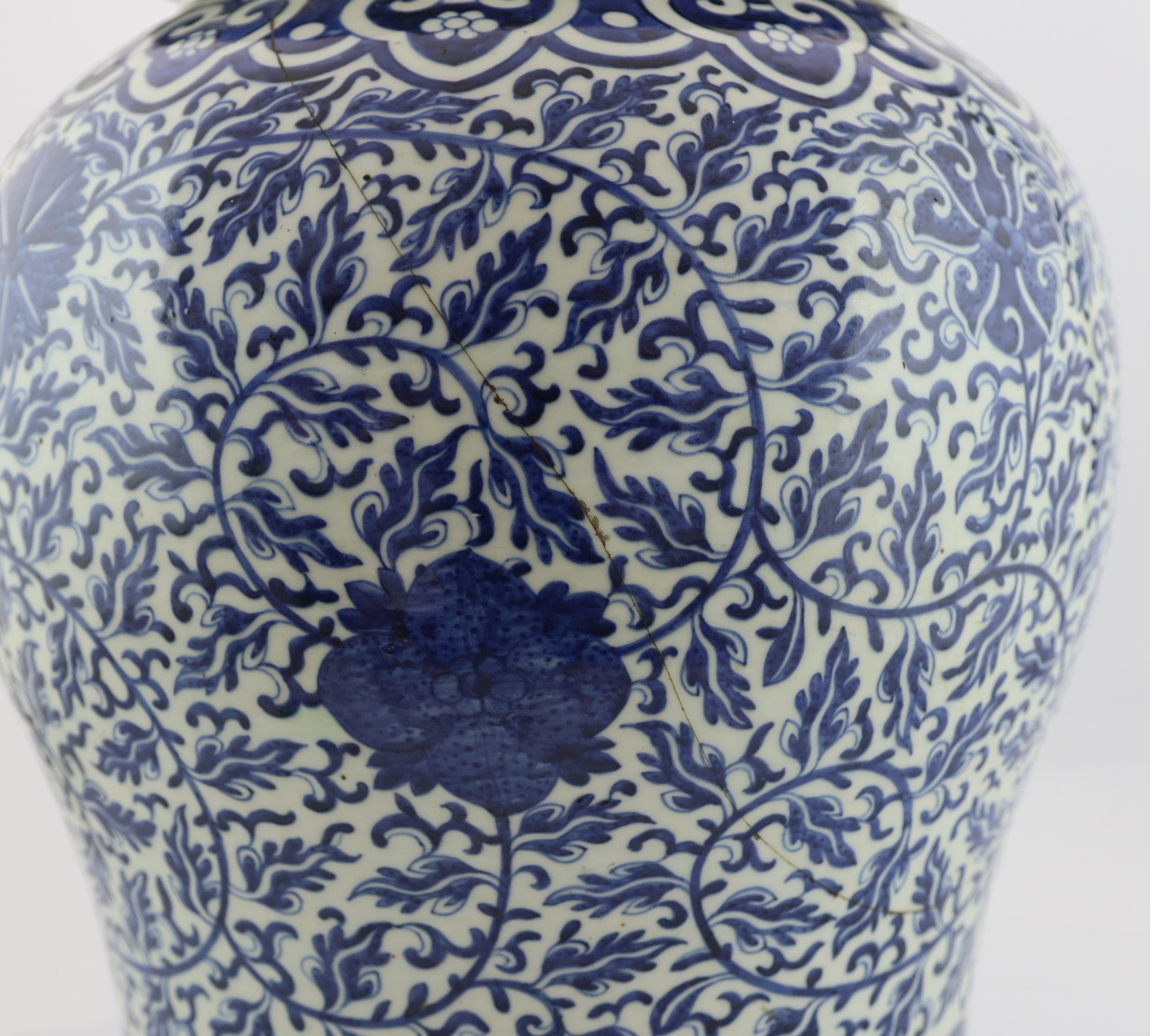 A massive Chinese blue and white ‘lotus’ vase and cover, 18th/19th century, broken and glued